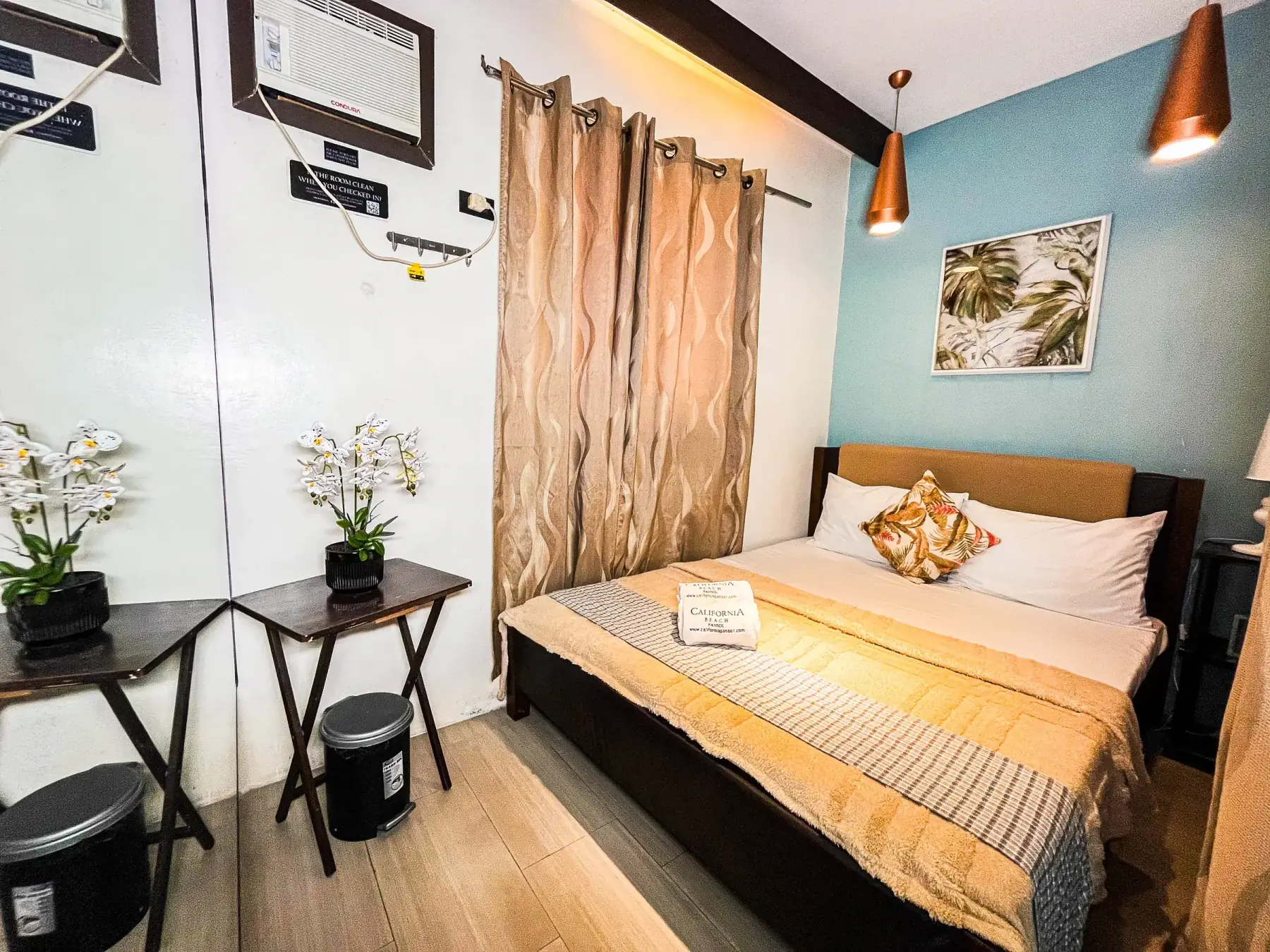 Casita — master bedroom with a queen bed and copper pendant lights