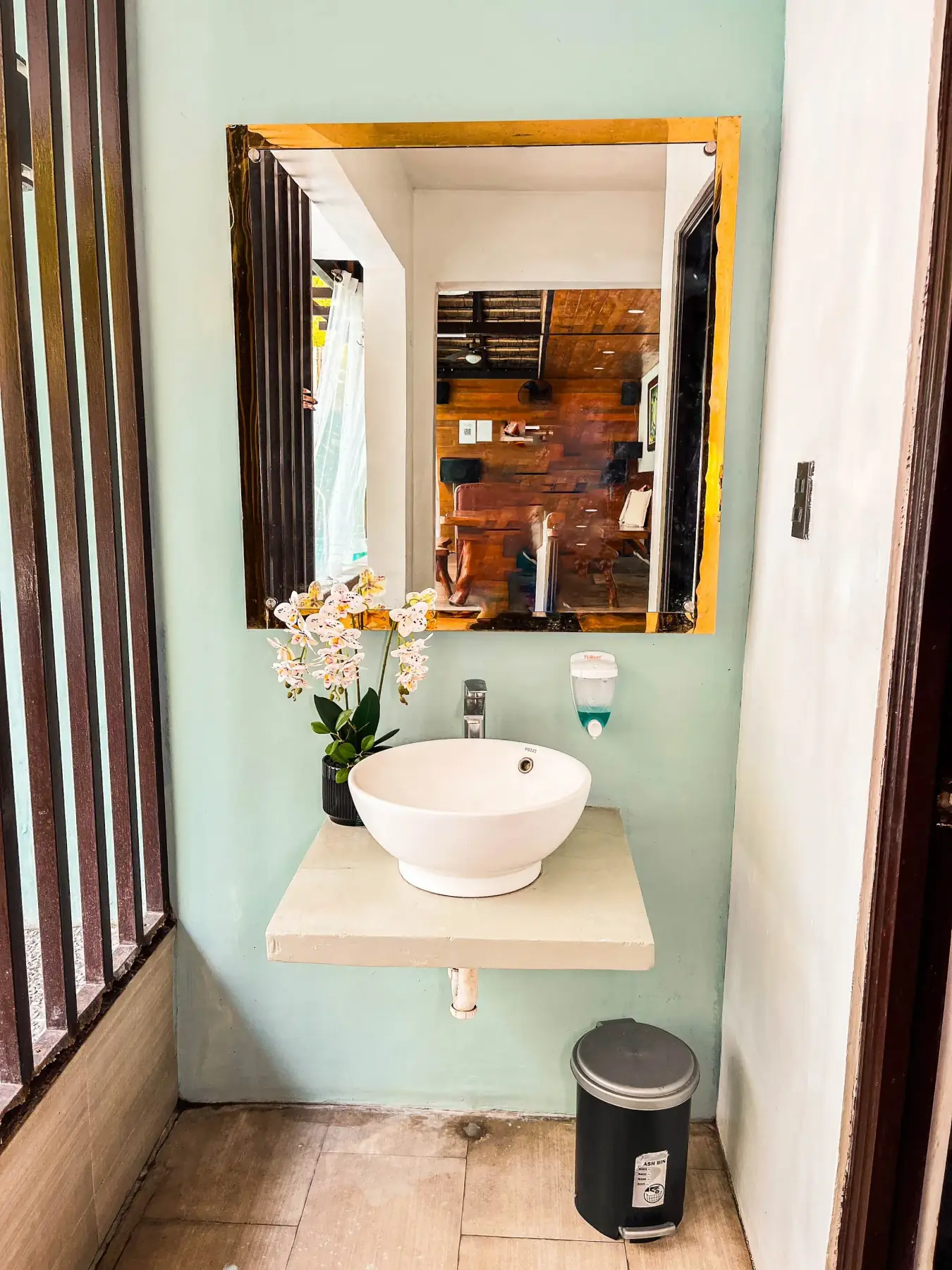 Casita — bathroom vanity with vessel basin and orchid