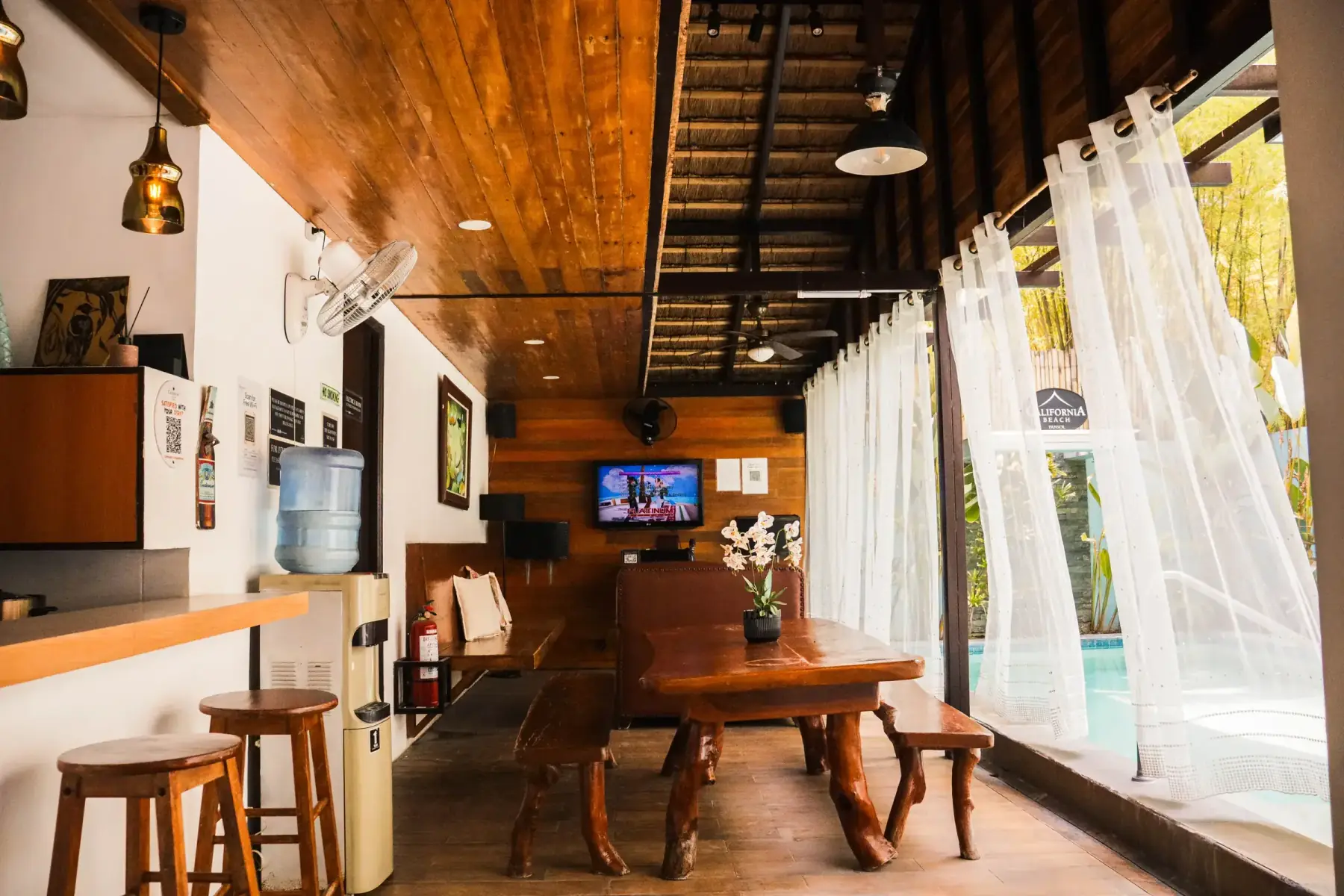 Casita — great-room dining with a log table and benches