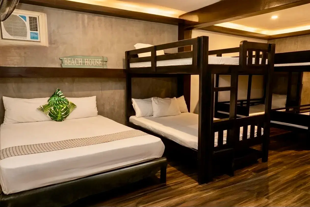 Villa 1 — Common Room 1 with a queen bed and four double-deck singles