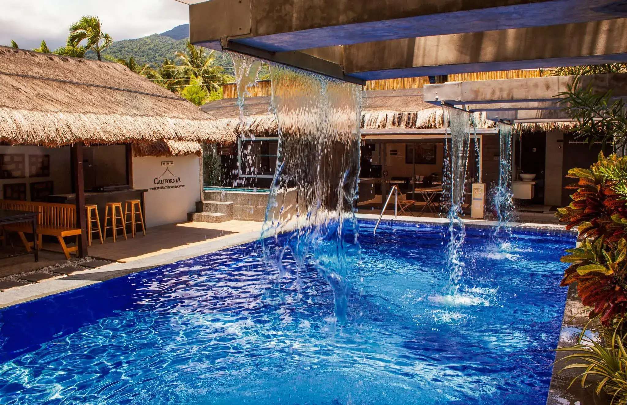 Villa 1 — private hot-spring pool with twin waterfalls and shade sails