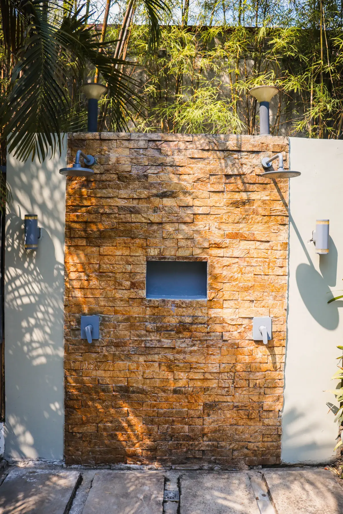 Villa 2 — open-air stone shower with twin shower heads