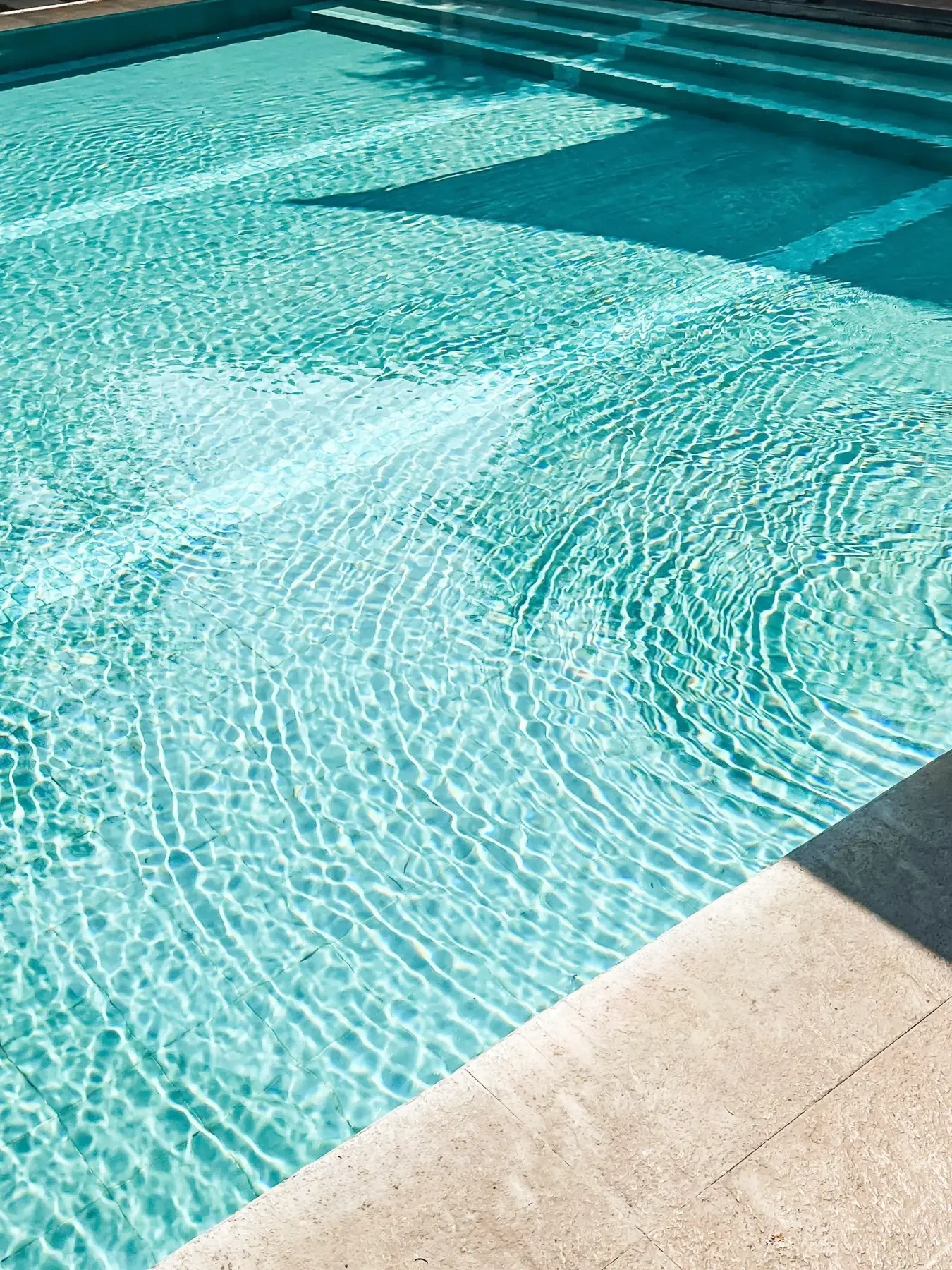 Villa 2 — sunlit turquoise water of the private pool, close detail