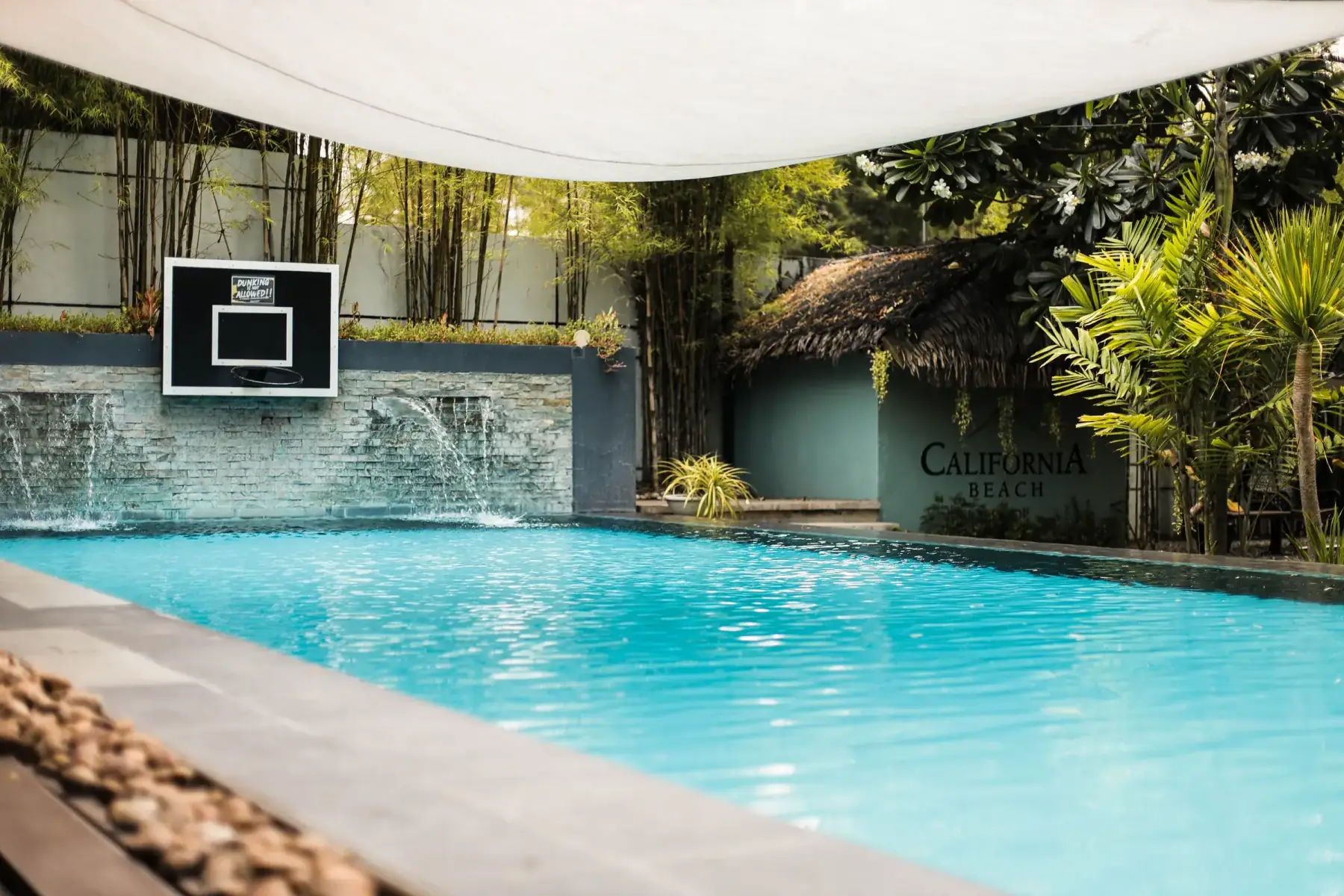Villa 3 — pool with a waterfall wall and basketball hoop